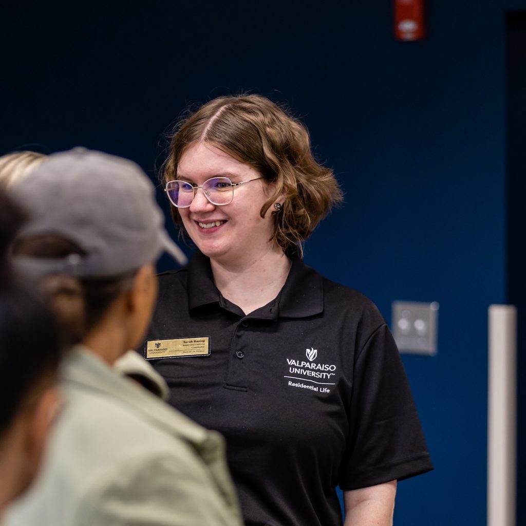 Sarah Rasing, M.Ed., smiles at an individual out of frame during FOCUS, new-student orientation.