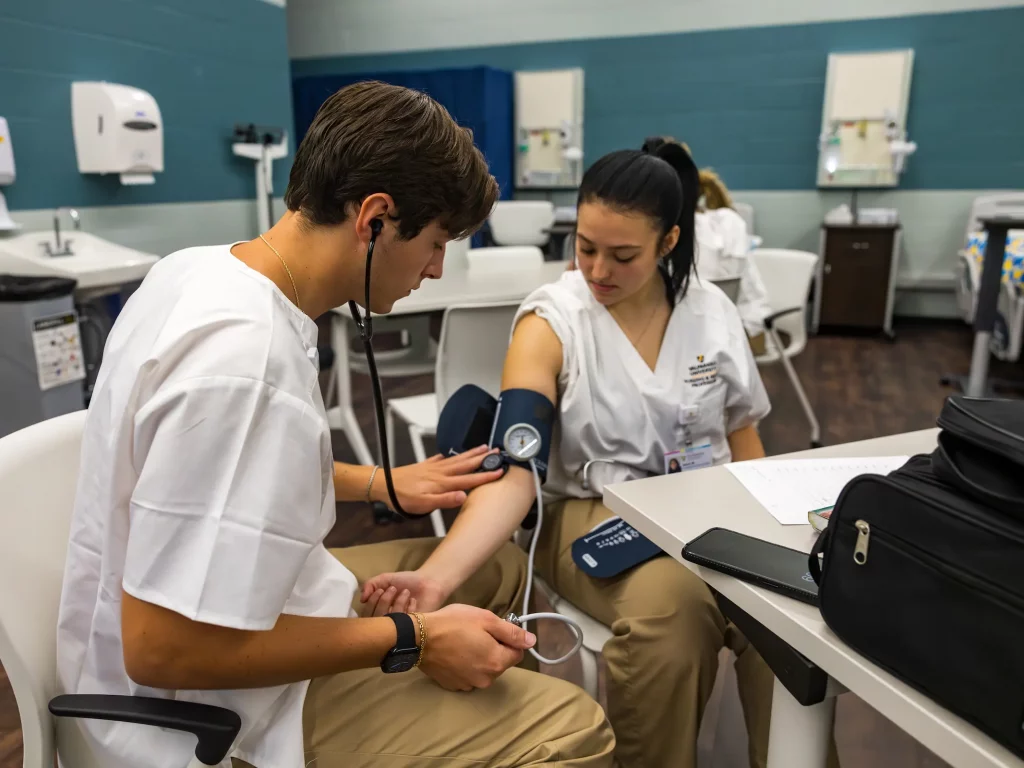 Student checking blood pressure