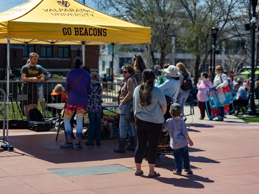 Valpo stand setup in Downtown Valpo with many visitors around it.