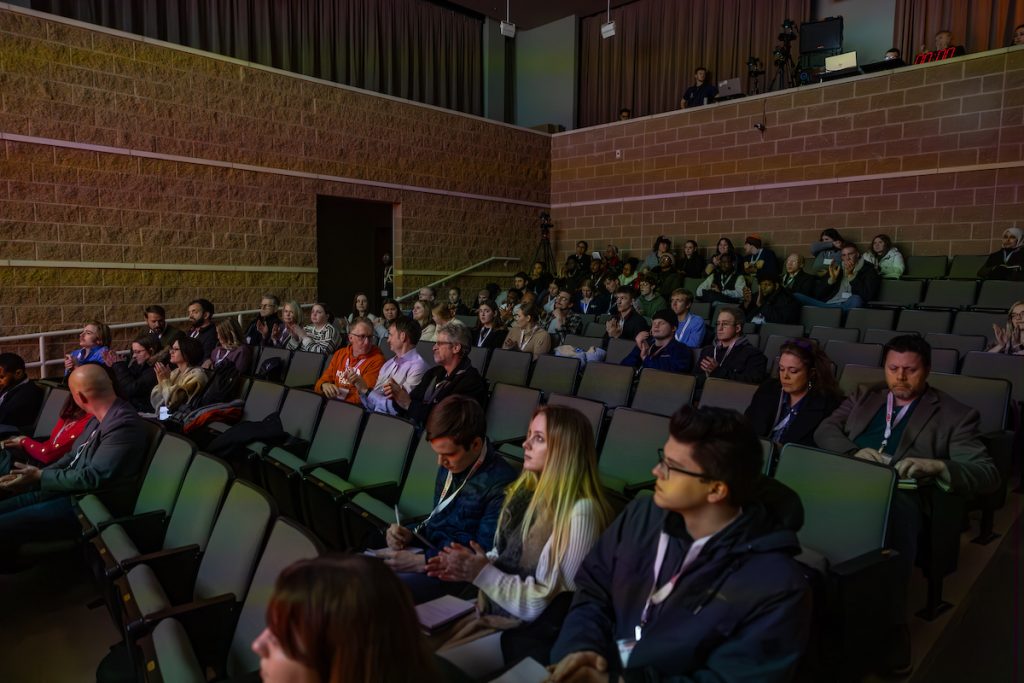 People sitting in on a presentation in an auditorium