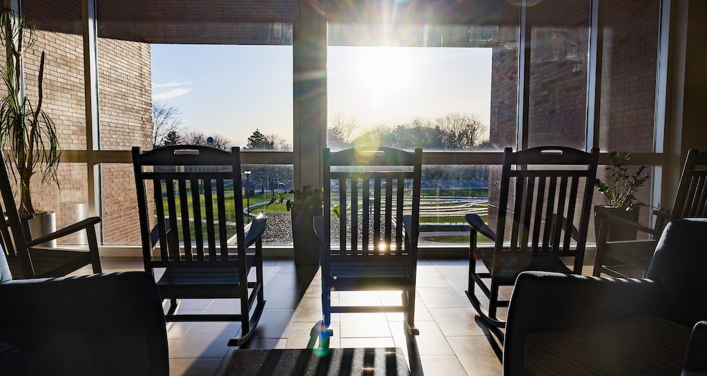 Chairs in front of window with the sun blairing through the window