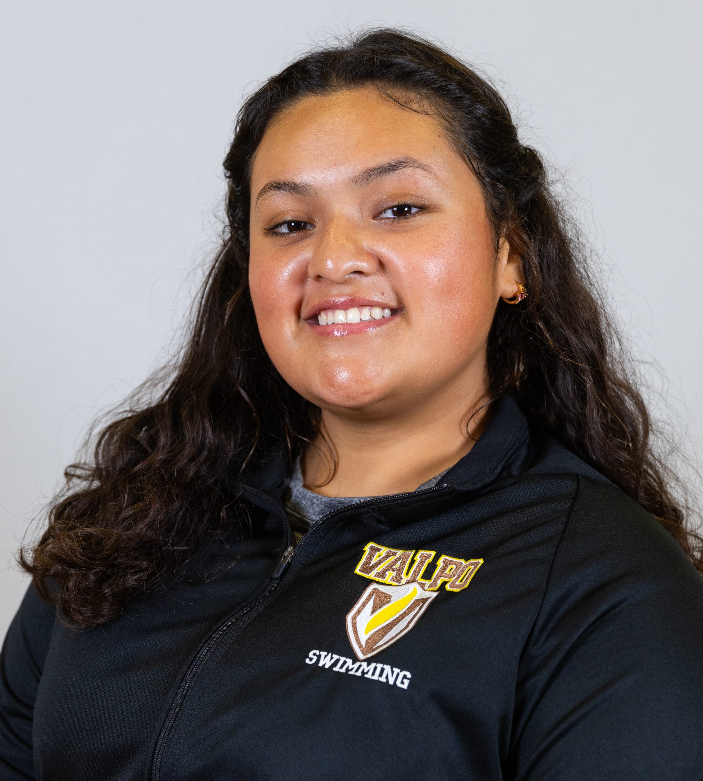 Jazzy Soria Gonzalez '24 smiling at the camera in professional attire.