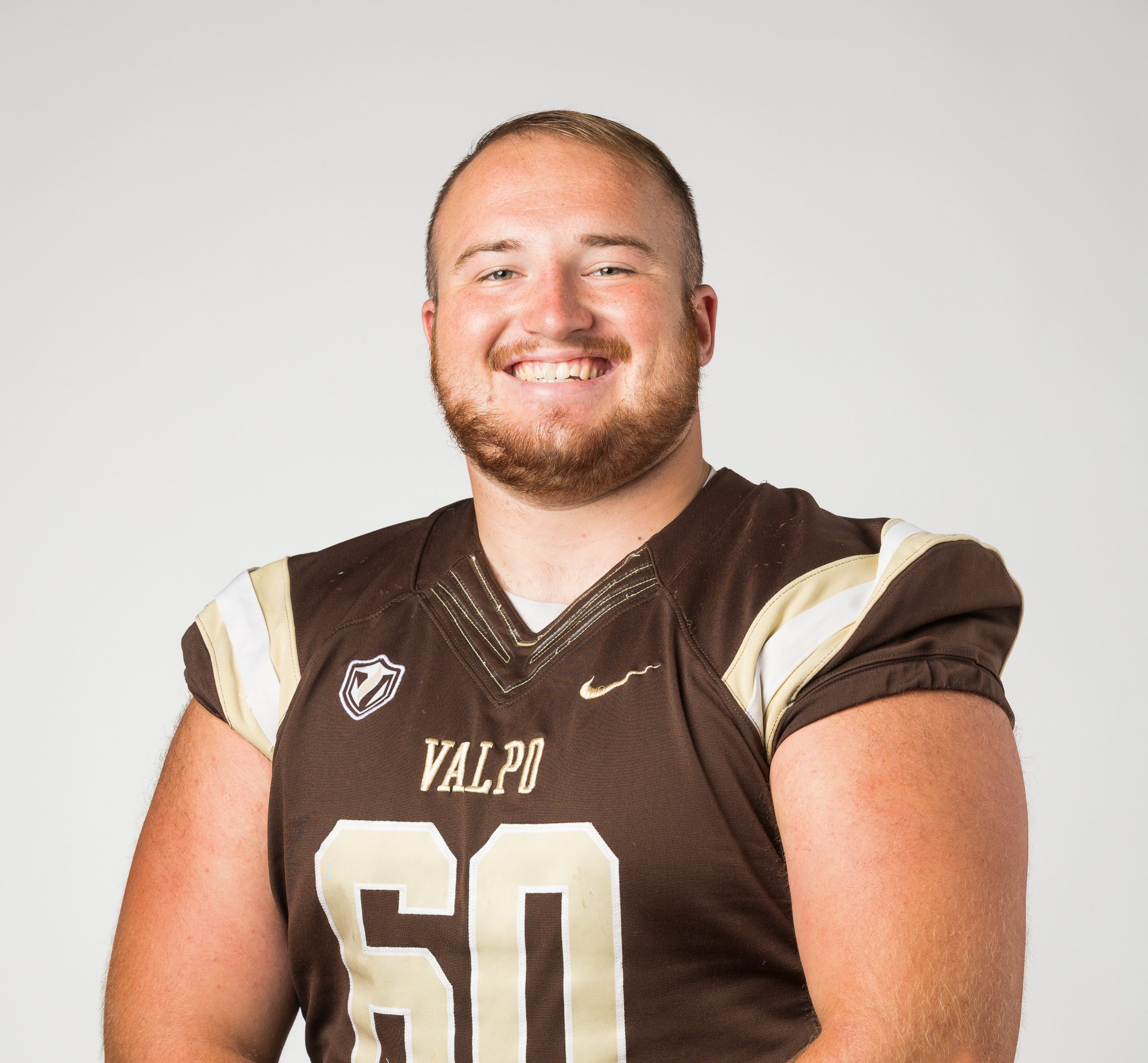 Graduate student-athlete Tyler Eberhart '24, '25 MBA, wearing brown, gold, and white Valpo football gear.