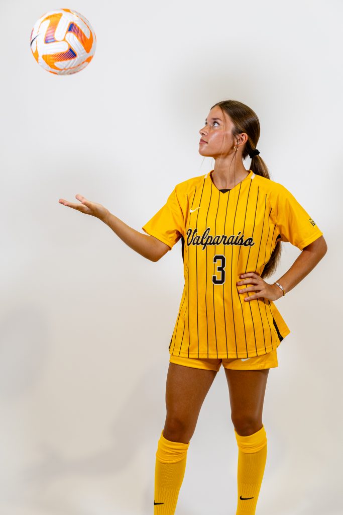 Valparaiso University nursing student-athlete Sam Gountounas '25 poses with a soccer ball.