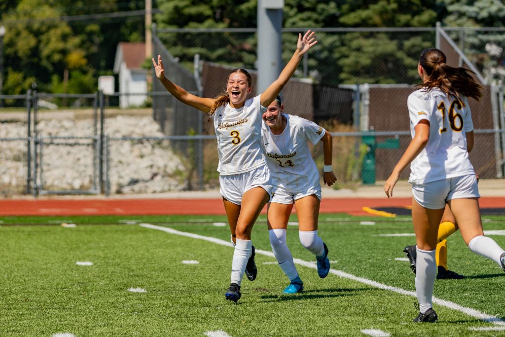 Valparaiso University nursing student-athlete Sam Gountounas '25 smiles in brown and gold soccer gear.