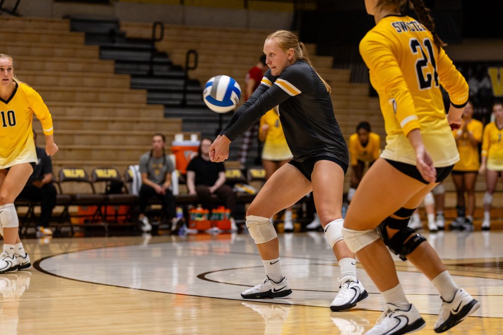 Valparaiso University student-athlete Emma Hickey '26 returns a serve in the middle of a Valpo Volleyball match.