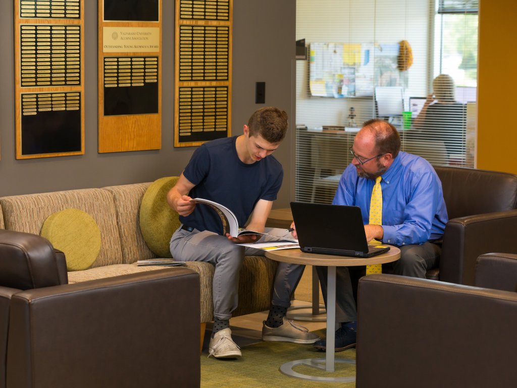 A student and school counselor sit and discuss college admissions and Valparaiso University tuition.